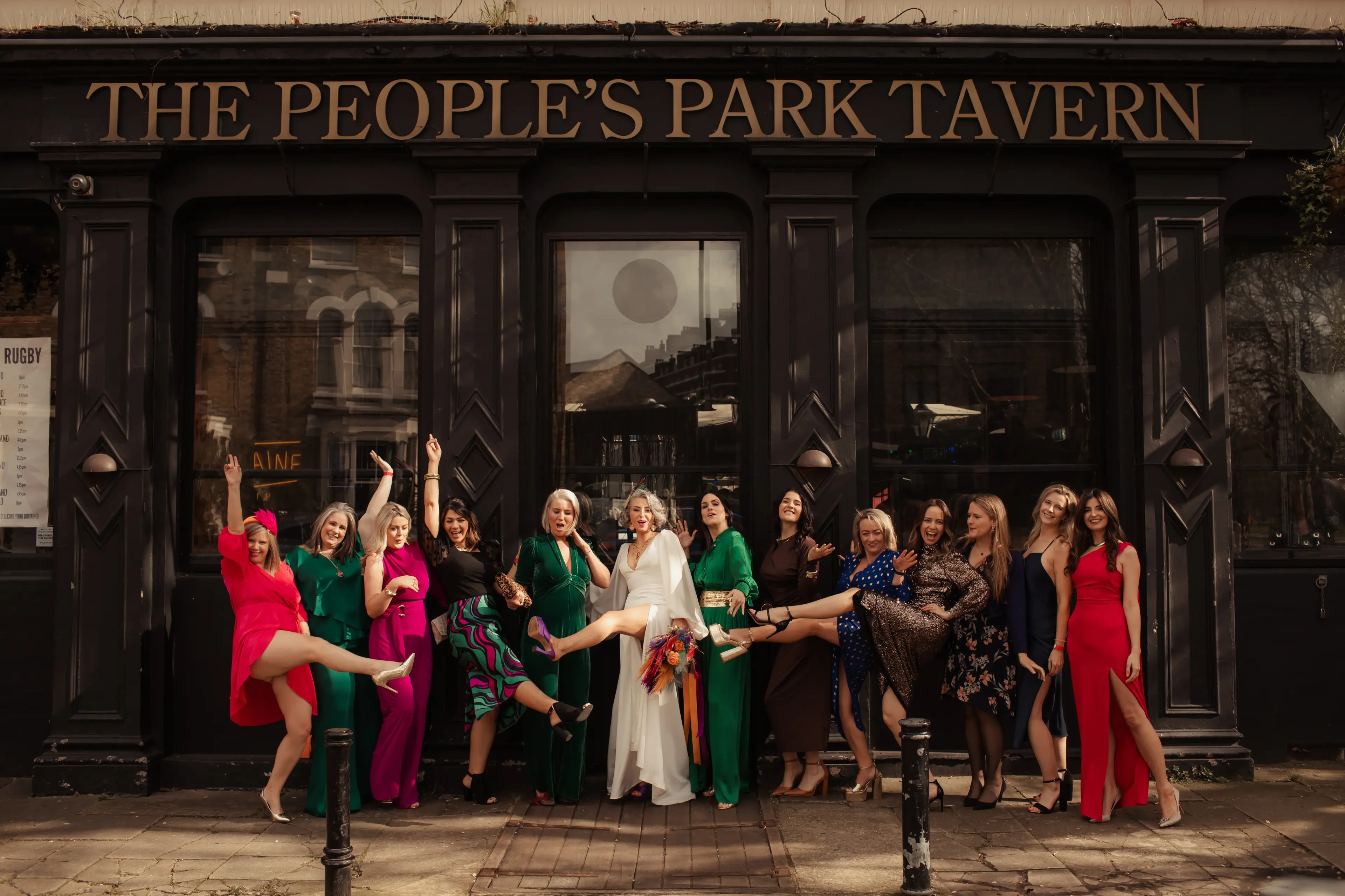 Newly married bride and friends celebrating outside the People's Park Tavern, London