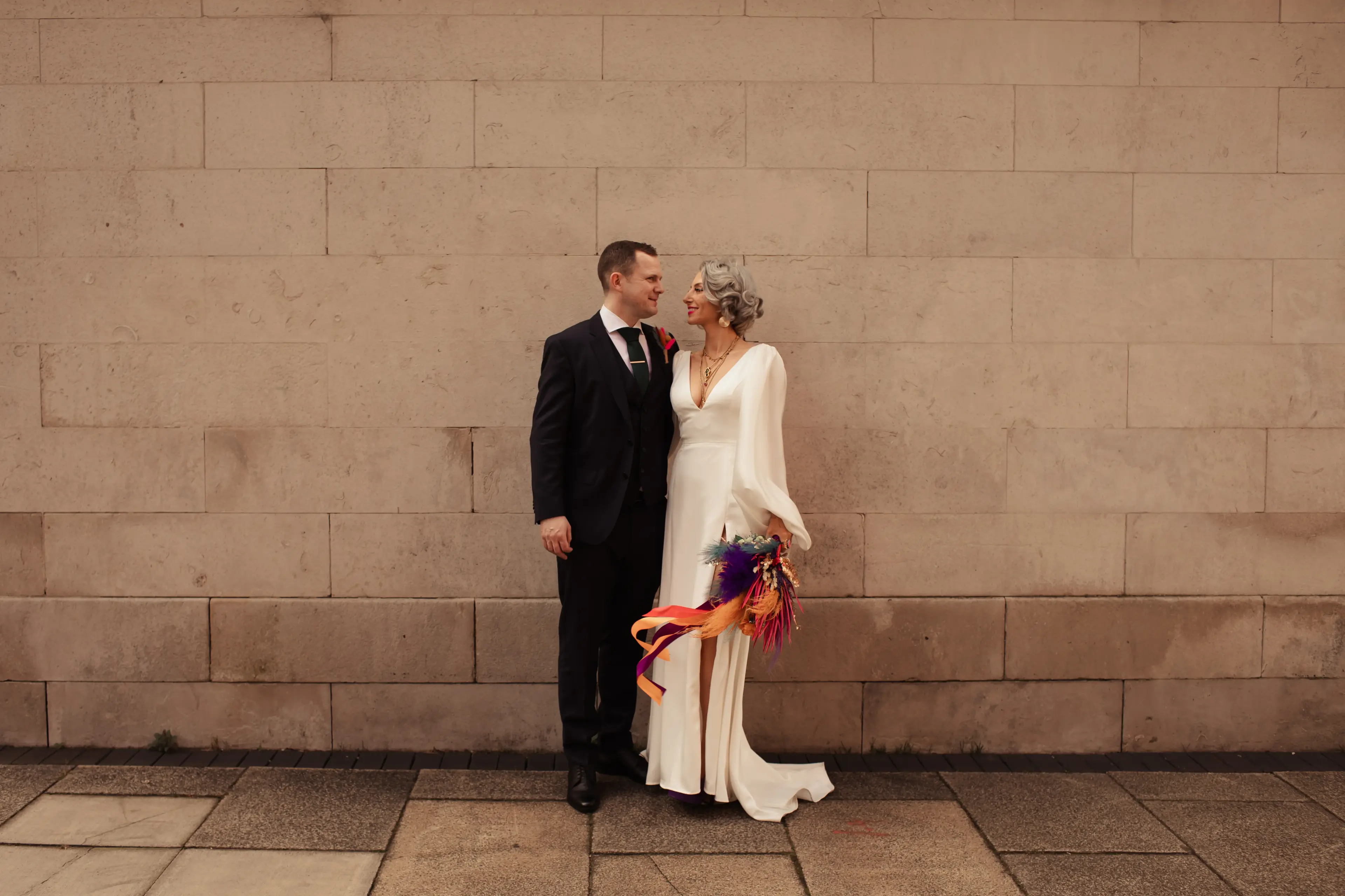 Bride and groom standing together outside Hackney Town Hall, London