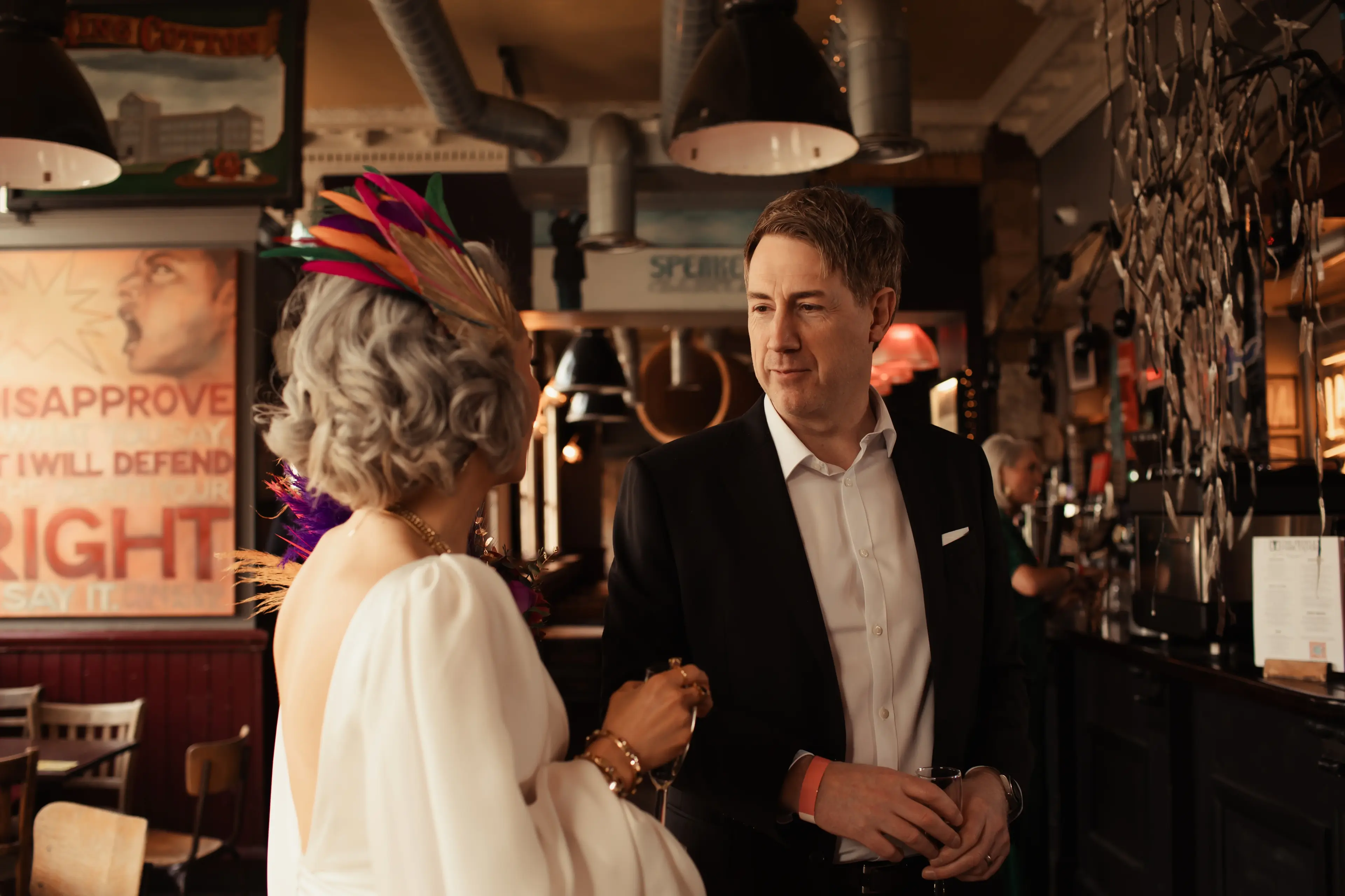 Bride having a moment to talk with a guest during a pub wedding in London