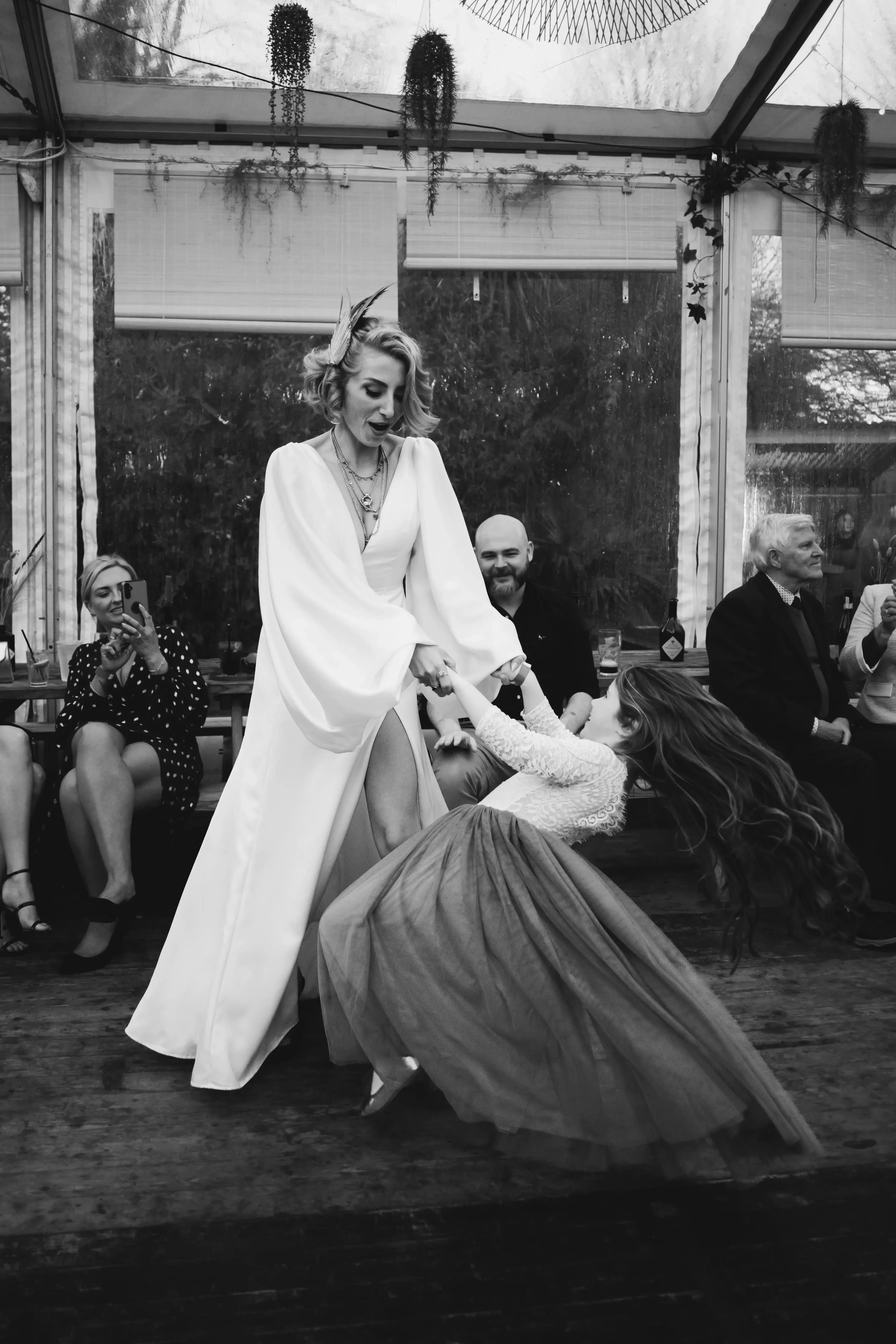 Bride dancing with her daughter during a London pub wedding reception