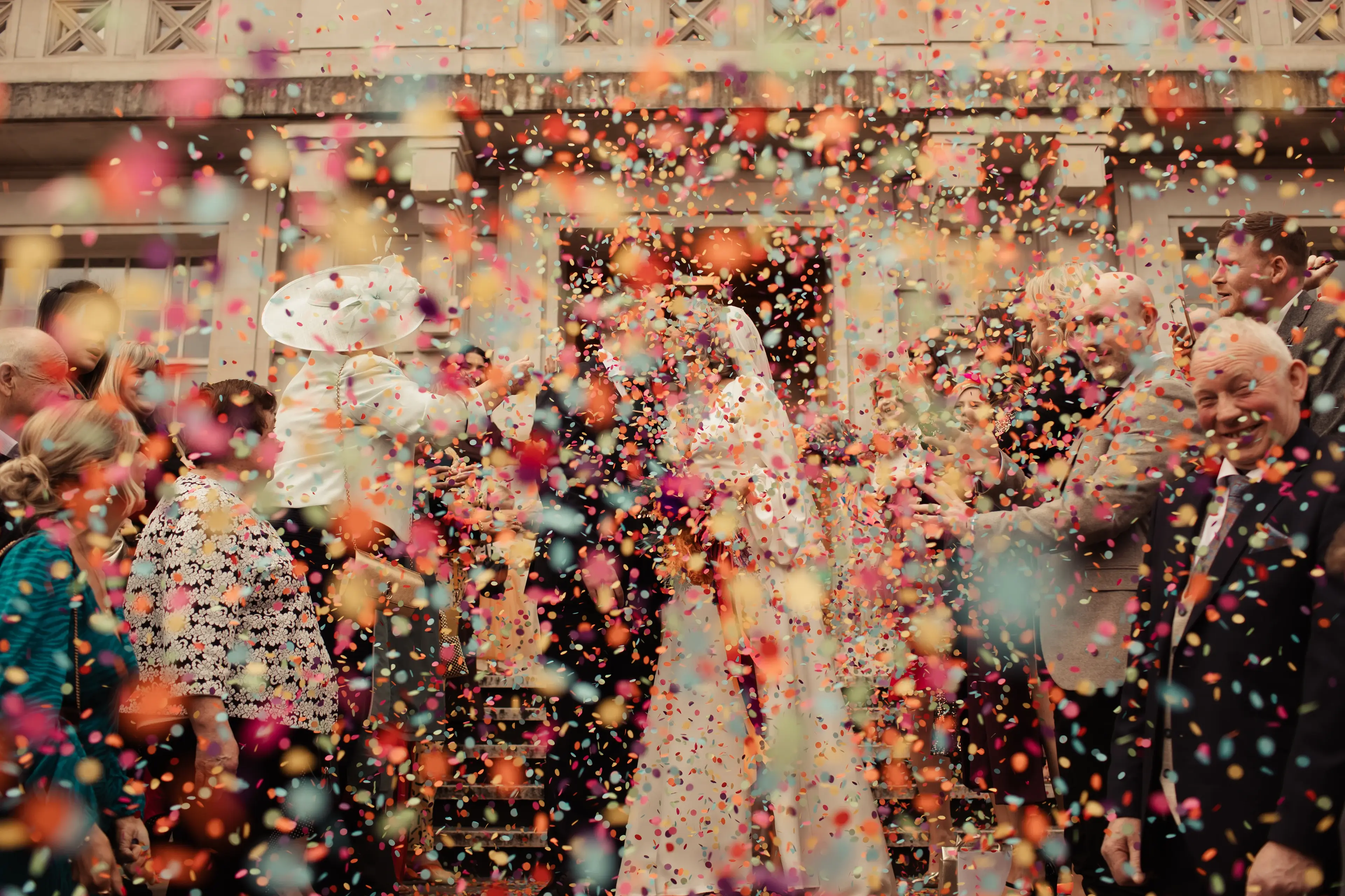 An explosion of colourful paper confetti at a Hackney Town Hall wedding