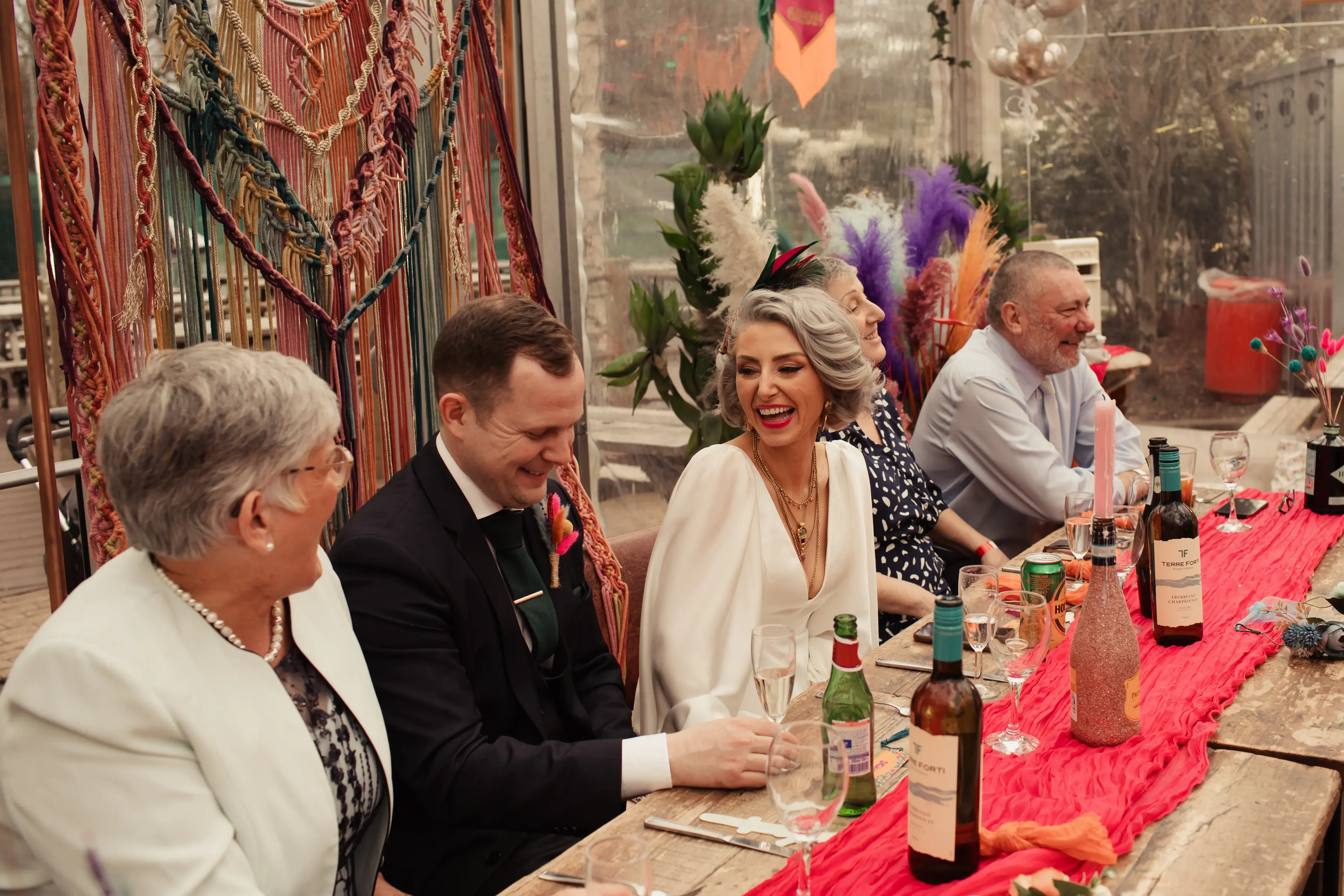 Bride laughing with groom during wedding speeches at a wedding reception in London