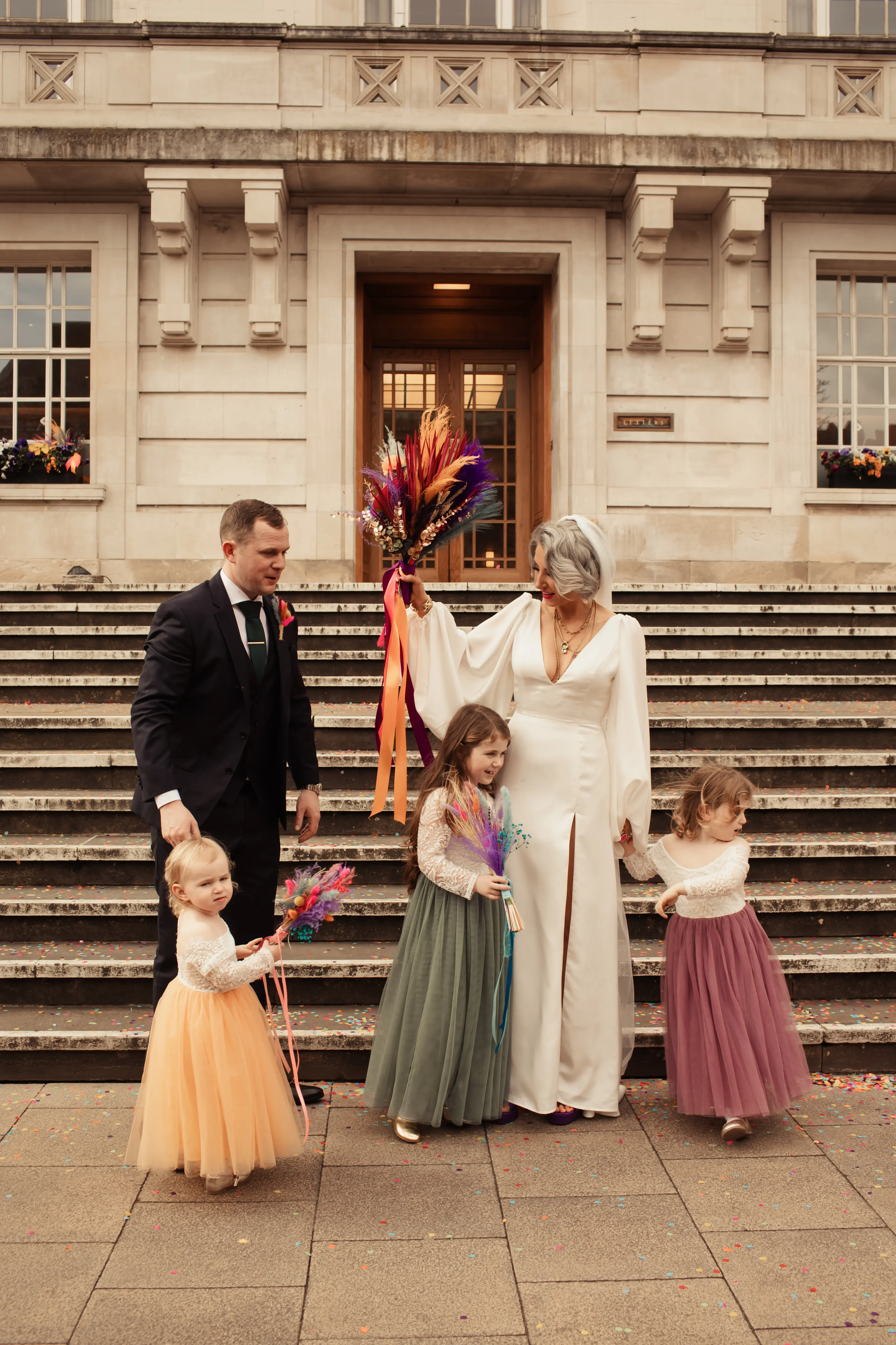 Bride and groom outside Hackney Town Hall with their children
