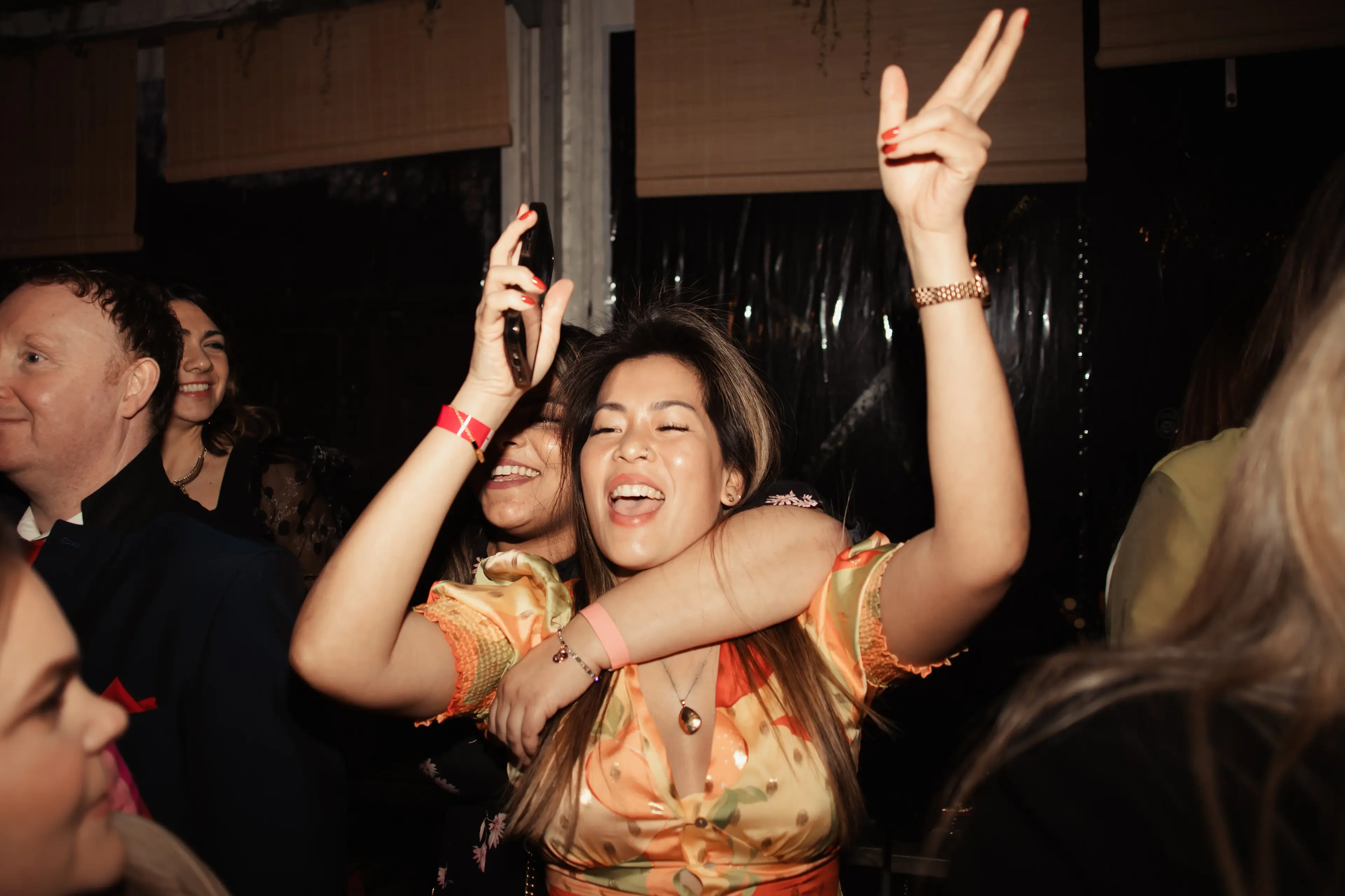 Wedding guests singing and dancing at a London pub wedding reception