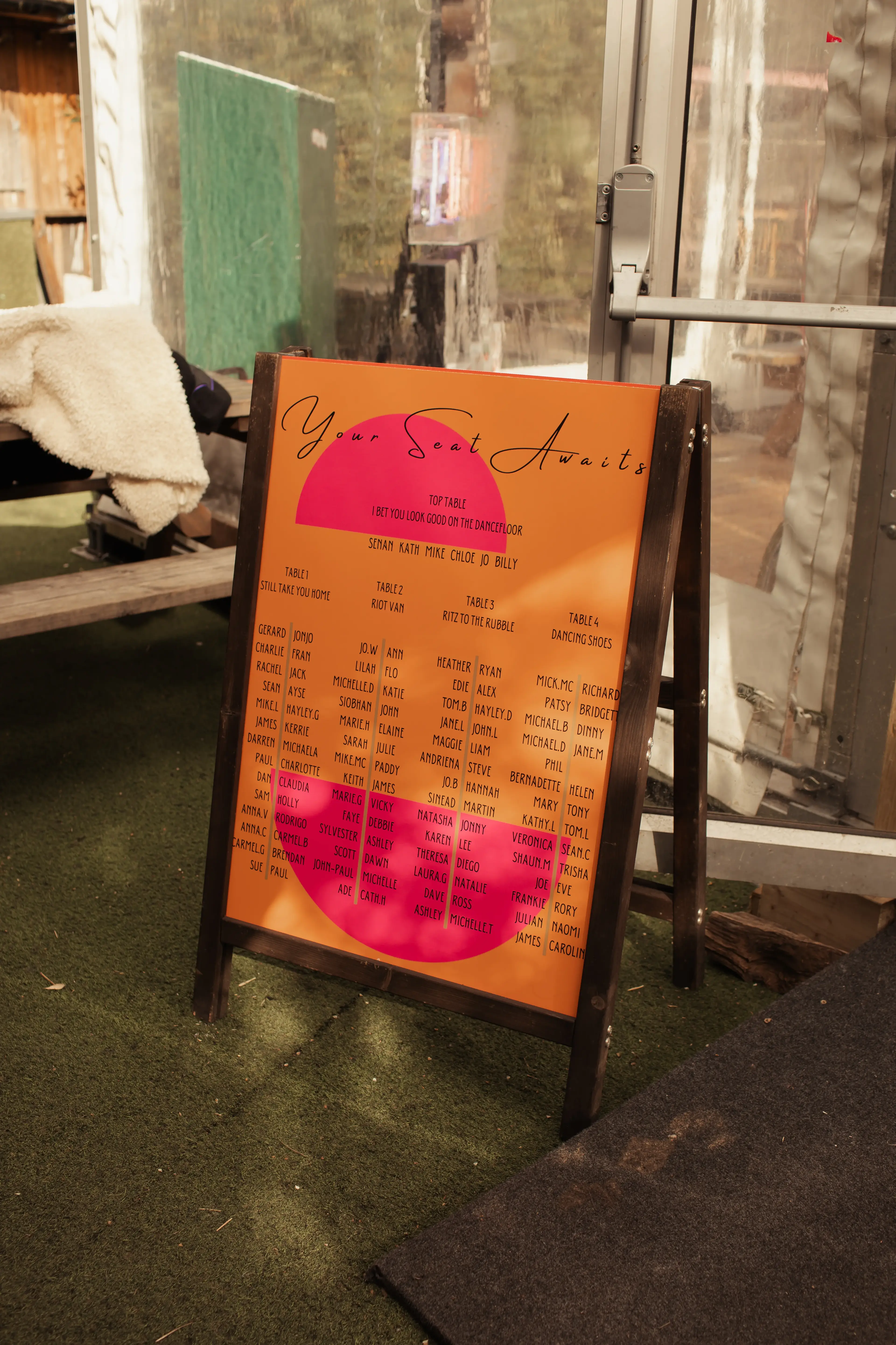 A colourfully styled table seating plan for a London wedding reception