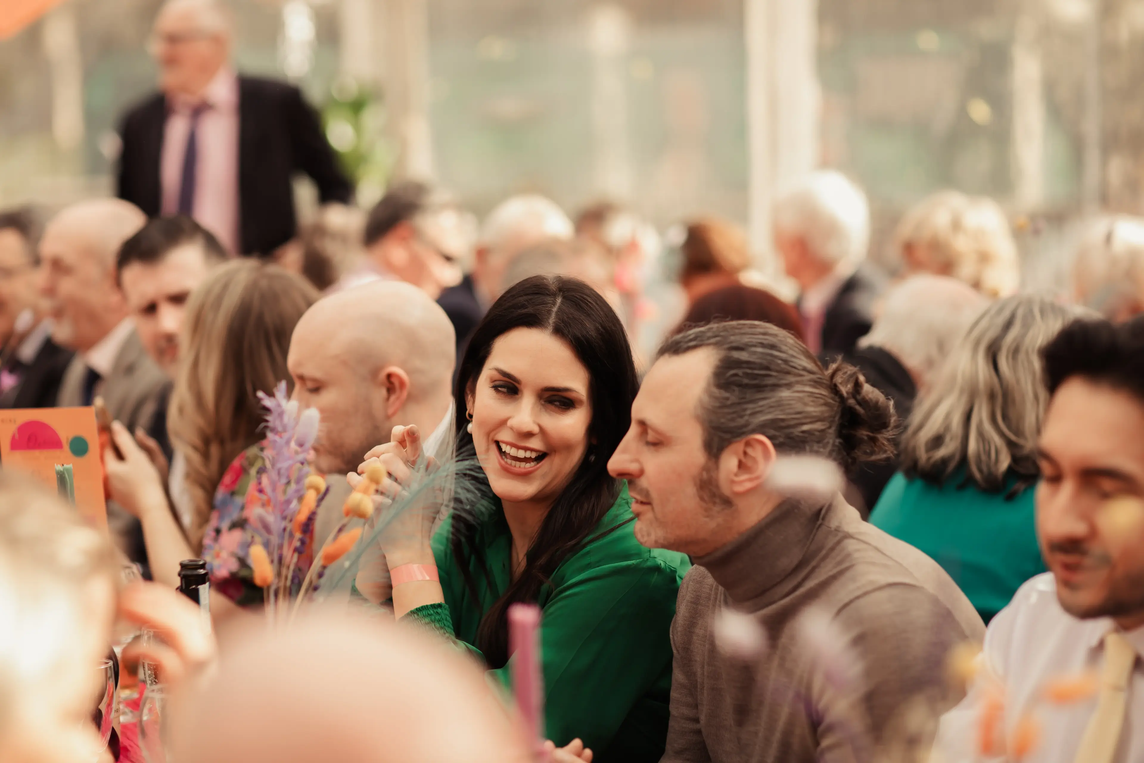 Guests laughing and chatting during a wedding reception at the People's Park Tavern, London