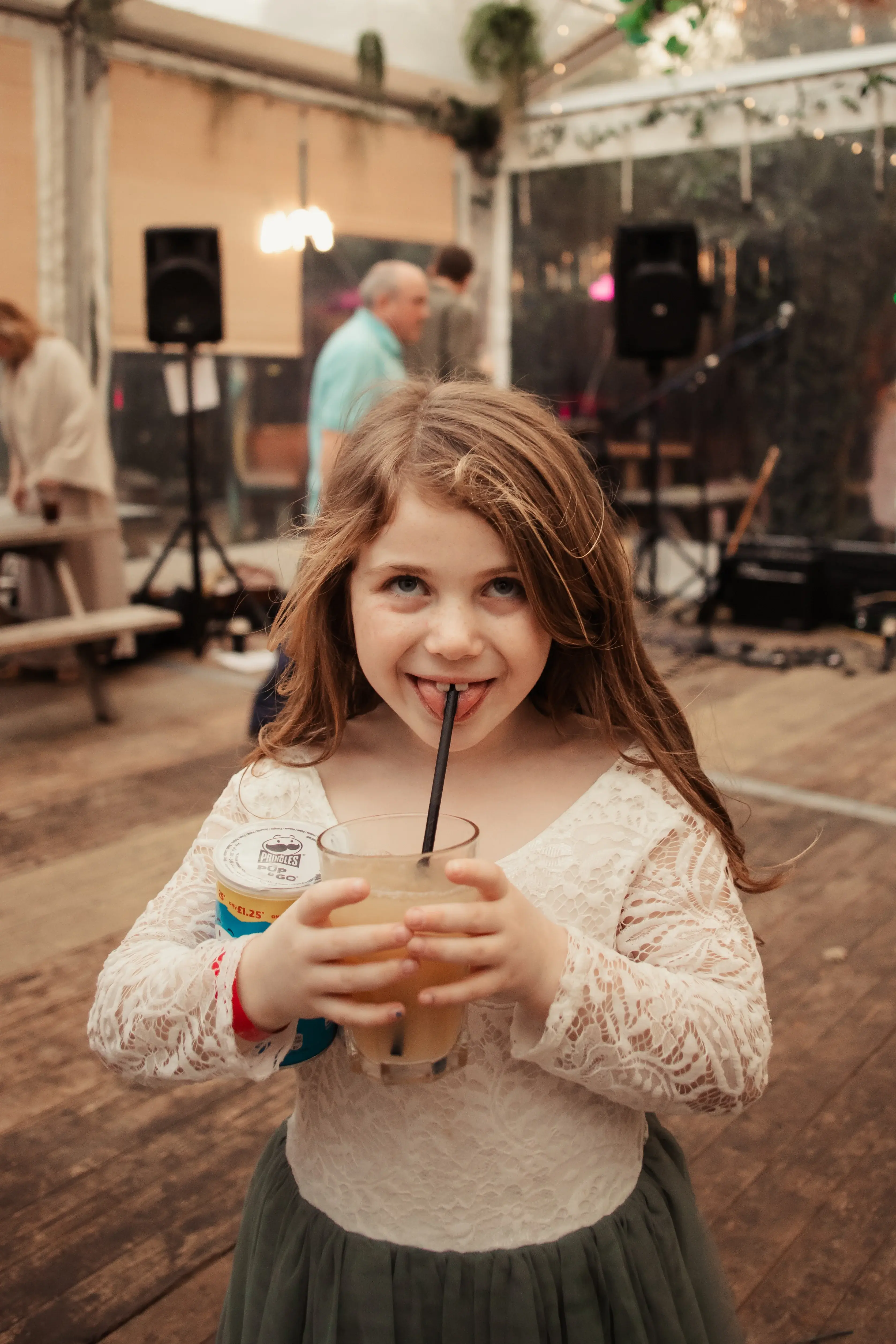 A young guest with a drink at a London pub wedding reception